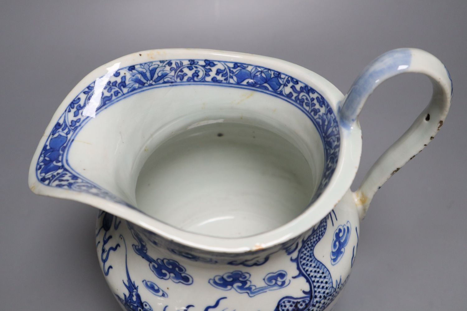 A 19th century Chinese blue and white dragon jug, 22cm
